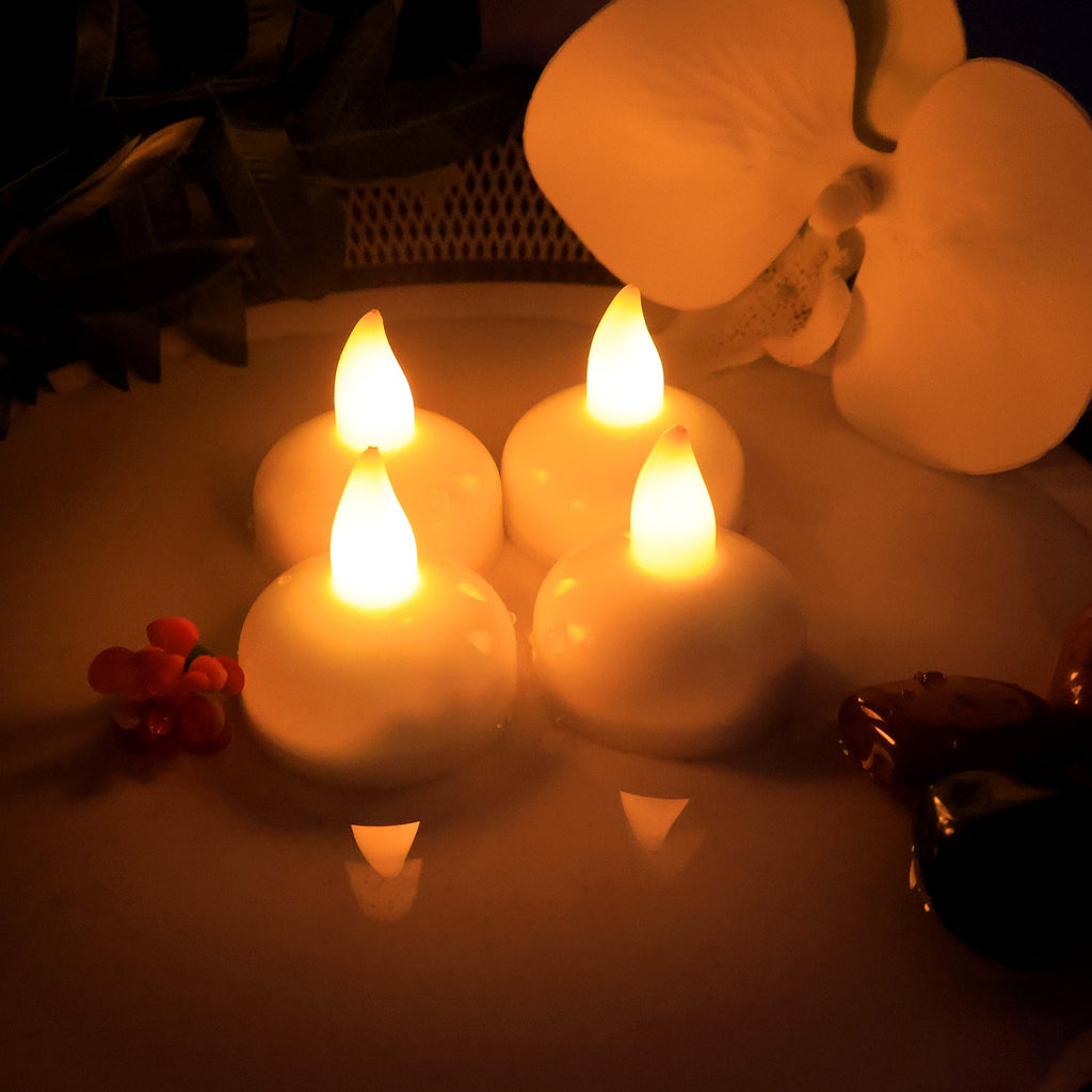 Floating lotus candles glowing on water