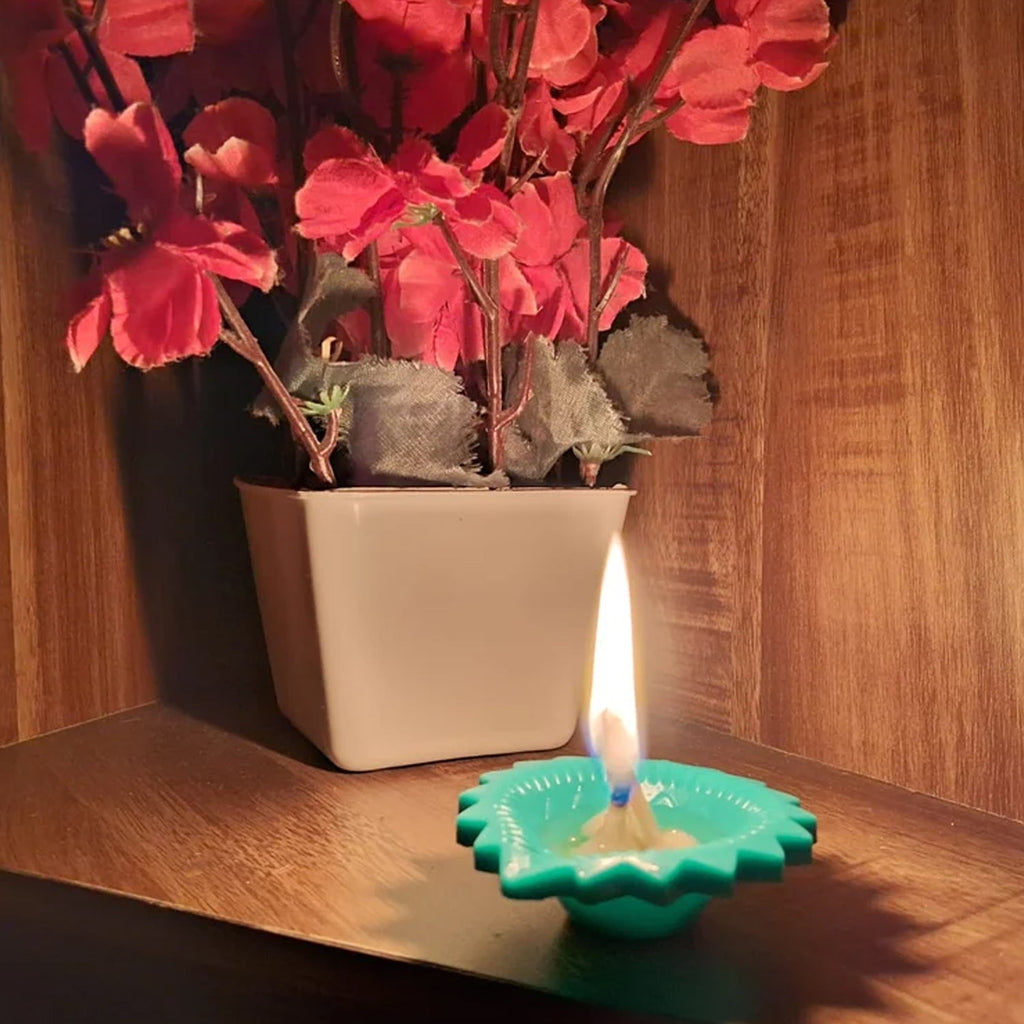 Lit silicone diya on a surface