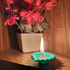 Lit silicone diya on a surface