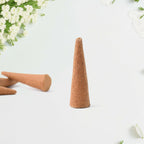 Resin dhoop cone held in hand for scale