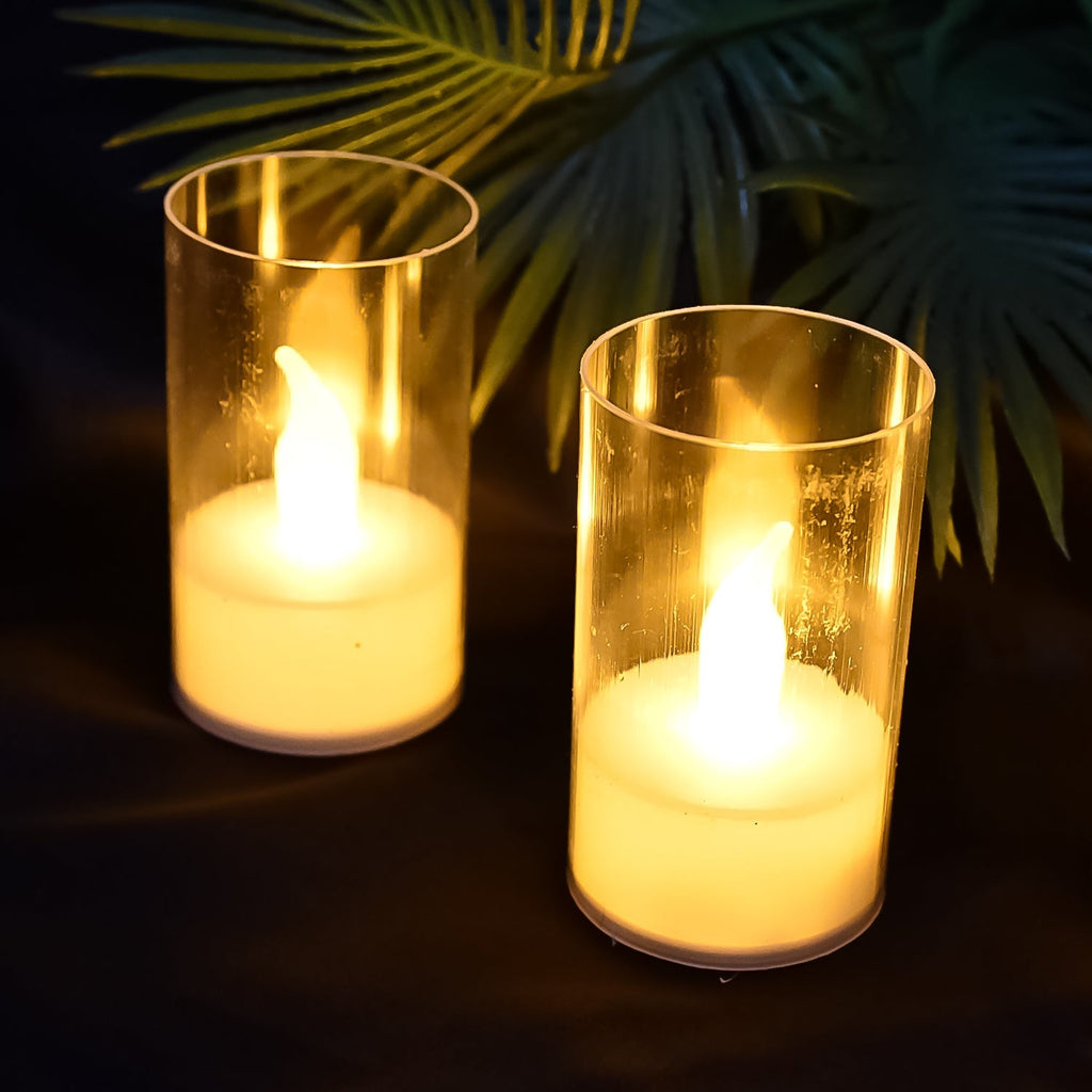 Two LED candles with covers glowing