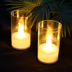 Two LED candles with covers glowing