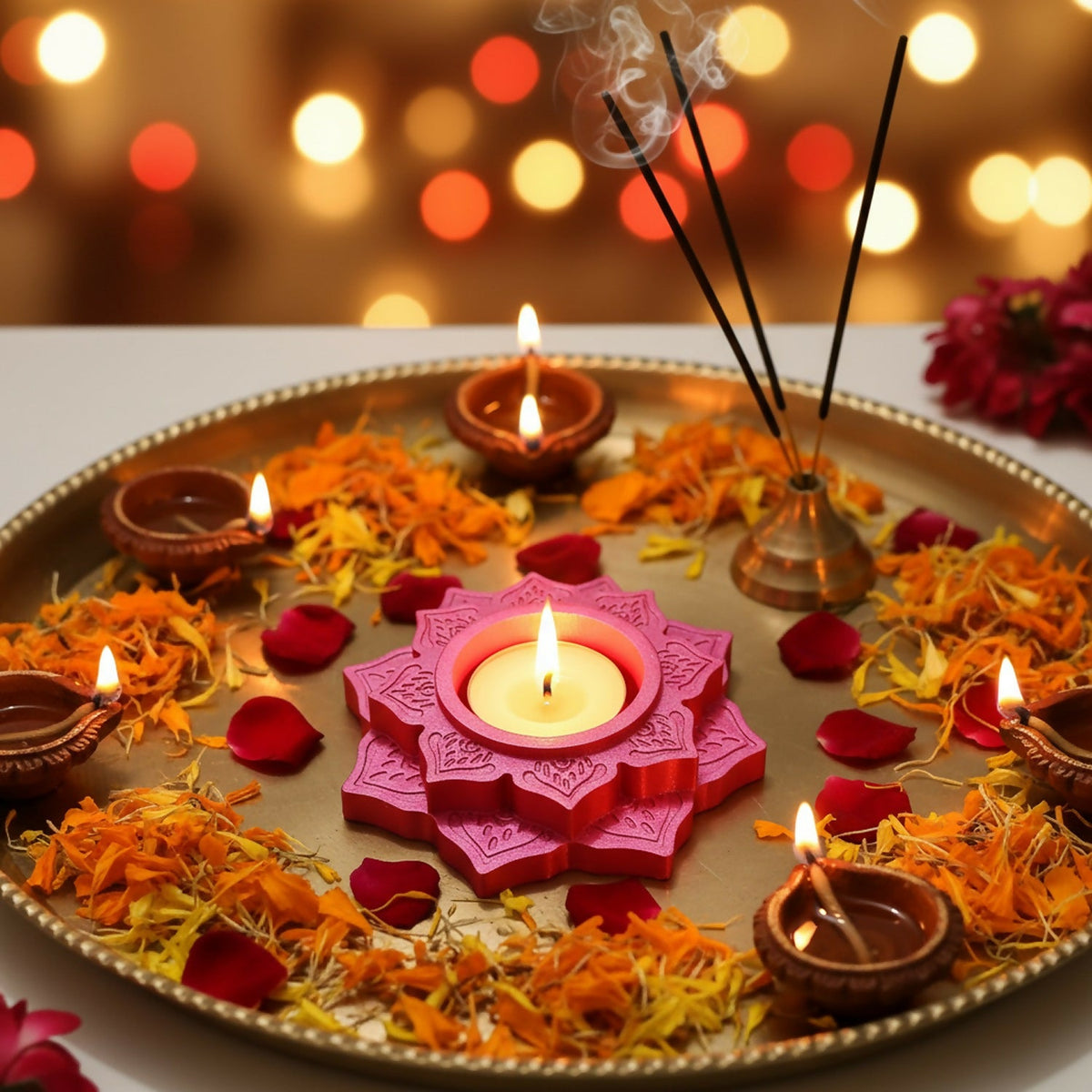 Lotus diya in a rangoli with marigolds