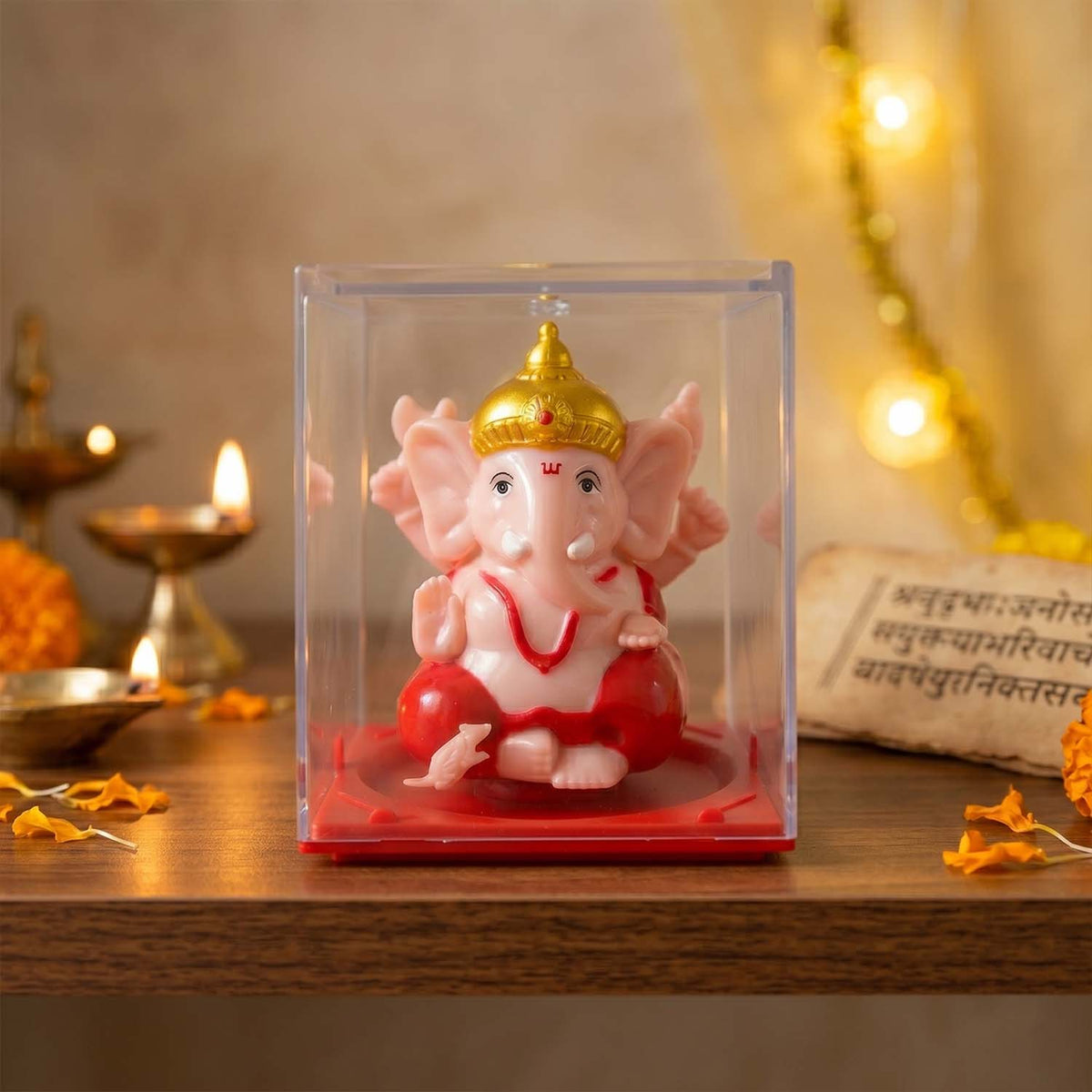 Ganesha idol in glass case on a table